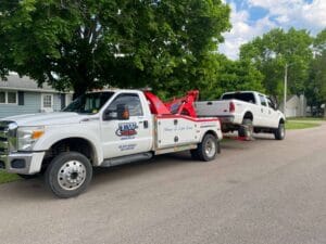 White truck towing another truck